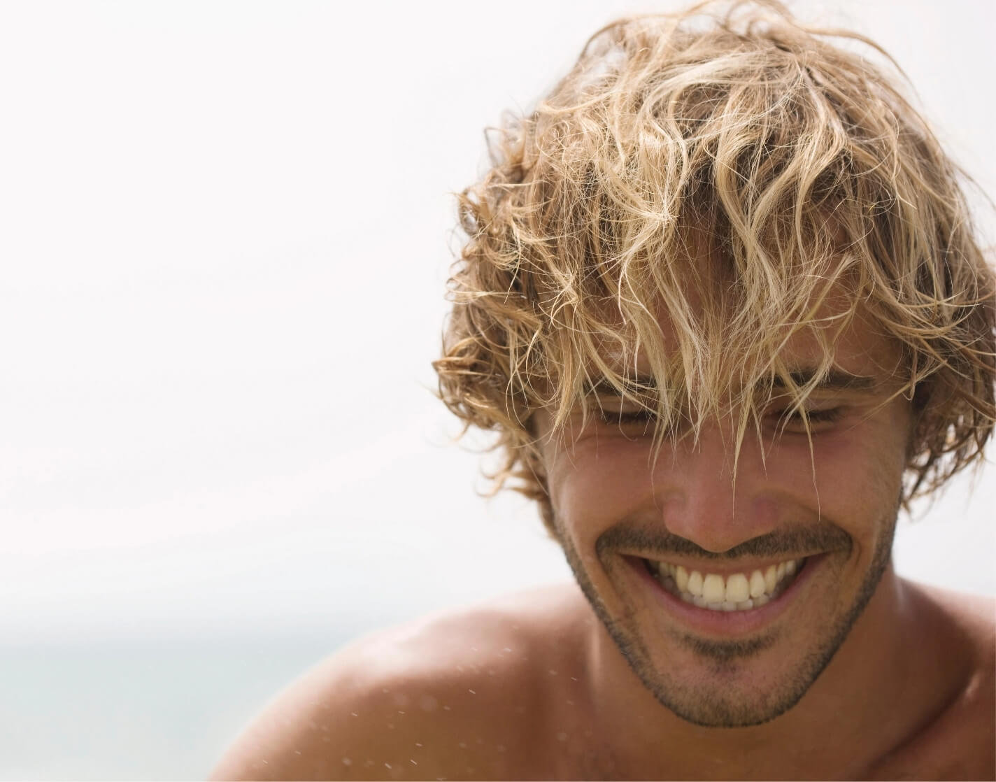 guy-looking-down-smiling-2023-11-27-05-19-33-utc@2x