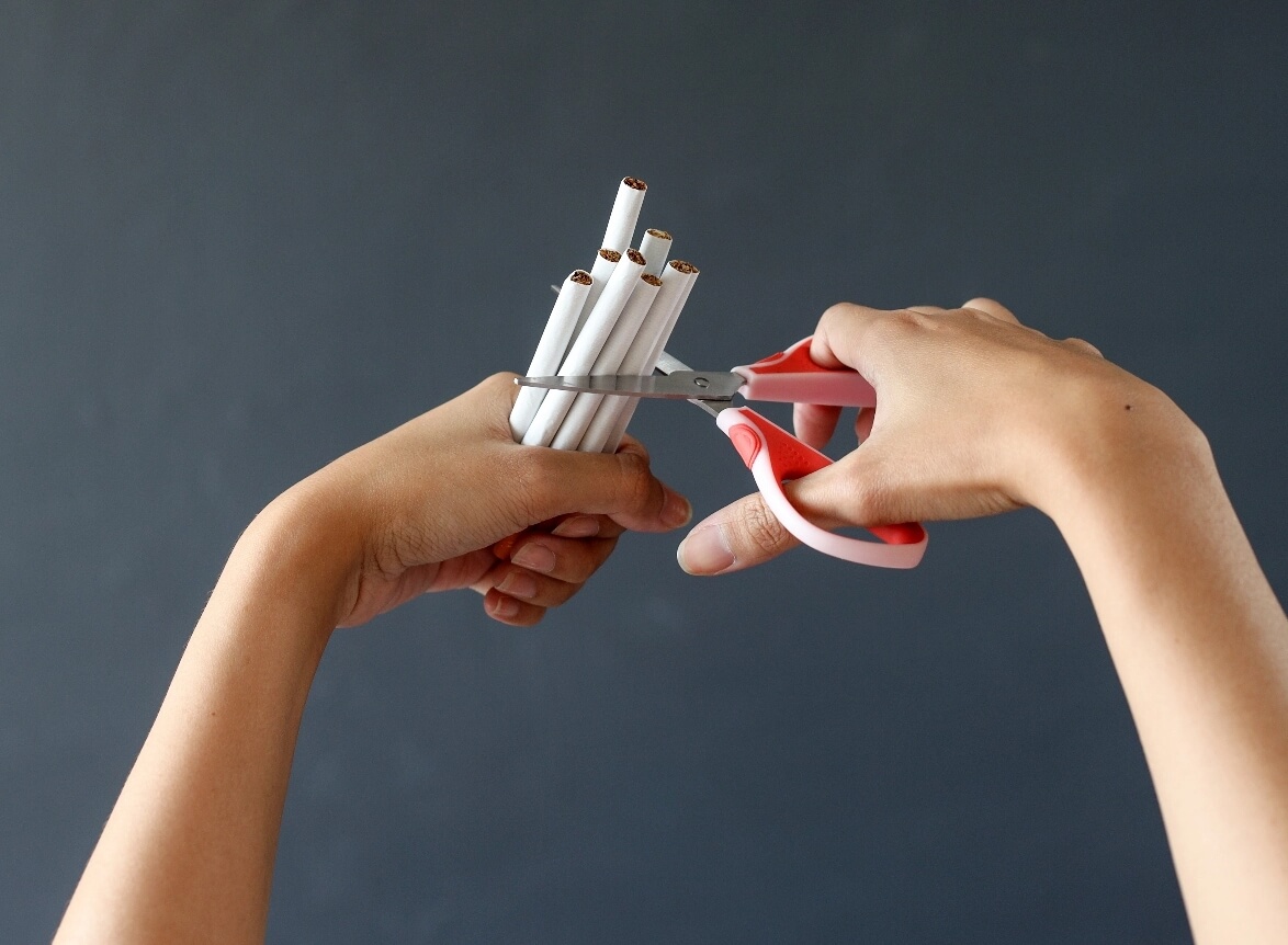 hand-crushing-cigarette-using-scissor-concept-of-2023-11-27-05-10-30-utc@2x