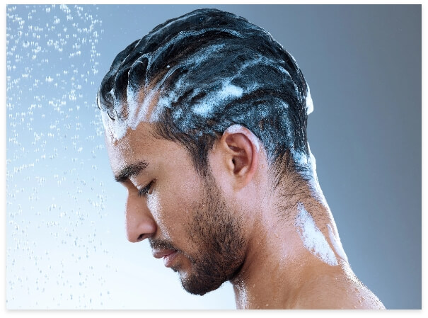 studio-shot-of-a-handsome-young-man-washing-his-ha-2023-11-27-05-21-59-utc