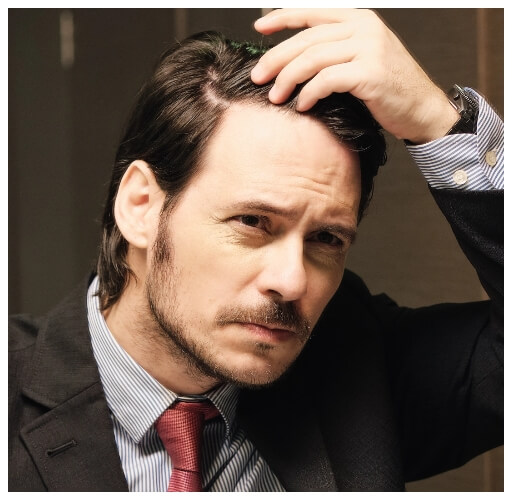 worried-hispanic-business-man-looking-at-hairline-2023-11-27-05-35-55-utc@2x