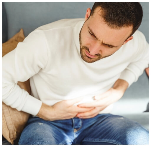 young-man-writhing-in-a-stomach-pain-2023-11-27-04-57-06-utc@2x